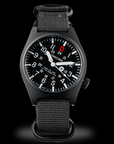 Close-up of Wancher Gurkha blackout dial with red zero marker and tilted face — affordable Japanese field watch for men