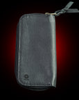 Black leather wallet with a zipper on a dark background Japanese artisanal leather pouch featuring air-beaten and embossed deer leather