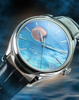 Luxury watch with blue face and black leather strap on a dark blue background Japanese raden dial automatic watch with moonphase complication