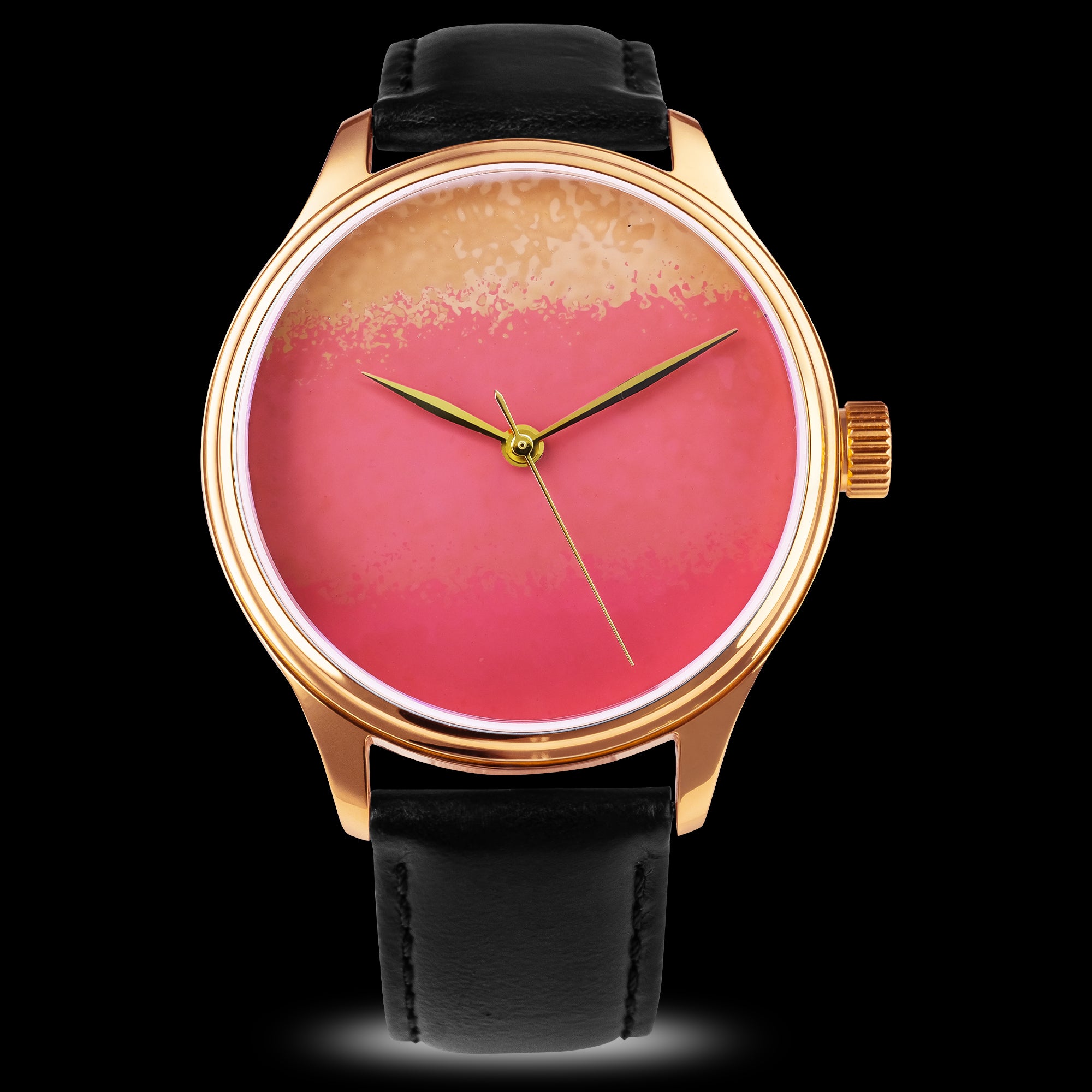 Wristwatch with a black leather strap and a pink and gold watch face on a black background