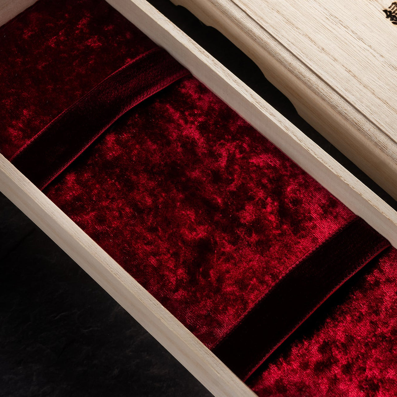 Wancher Watch Dream Watch Special Wooden box for the watch box with red interior and gold emblem on a dark background