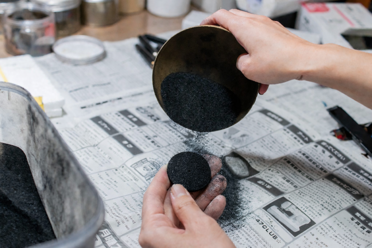 Charcoal Urushi Craftmanship, sprinking charcoal powder on a watch dial coated with urushi lacquer wancher watch urushi watch