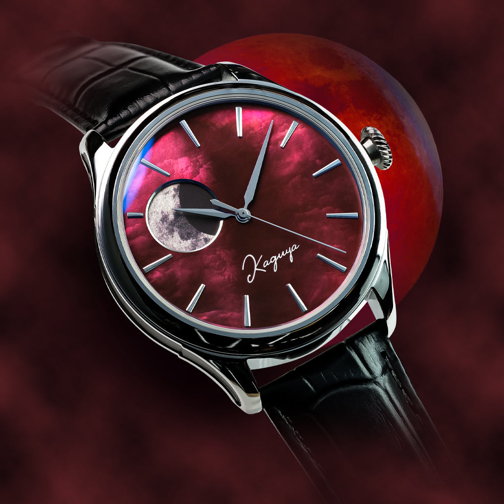 Luxury watch with red face and black leather strap on a dark background Luxury moonphase watch with Red Pantone ink dyed raden dial and graphic moon disk