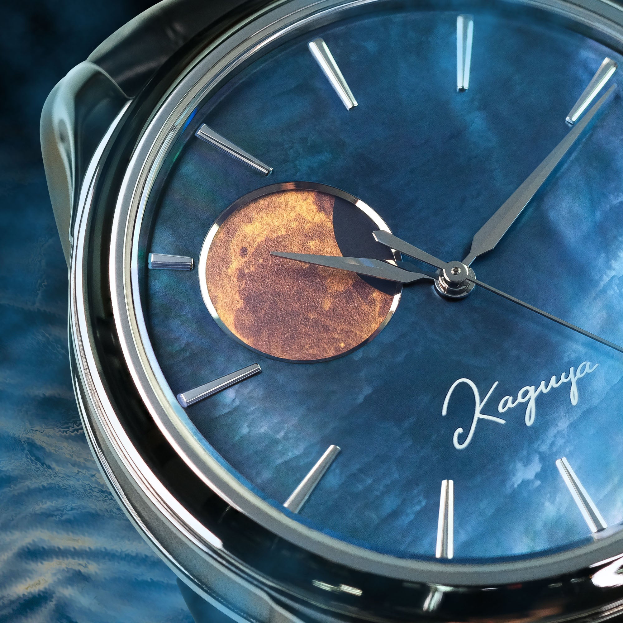 Close-up of a watch with a blue raden dial face and 'Kaguya' branding.\ and gold moon disk : Wancher raden dial watch featuring Kaguya-inspired moonphase display